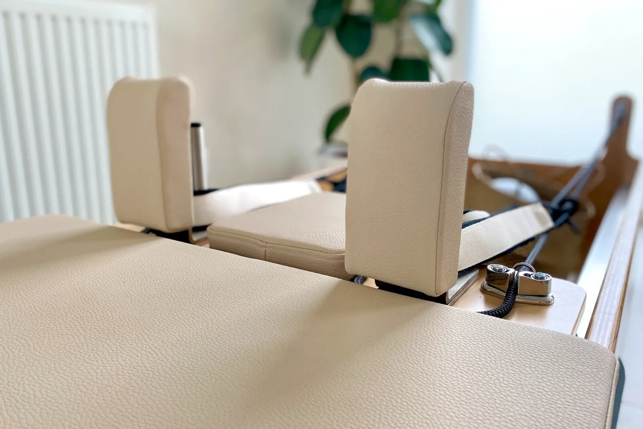 Close-up view of a beige Pilates reformer headrest and padding at Friday Reformer Pilates Studio in Budapest.